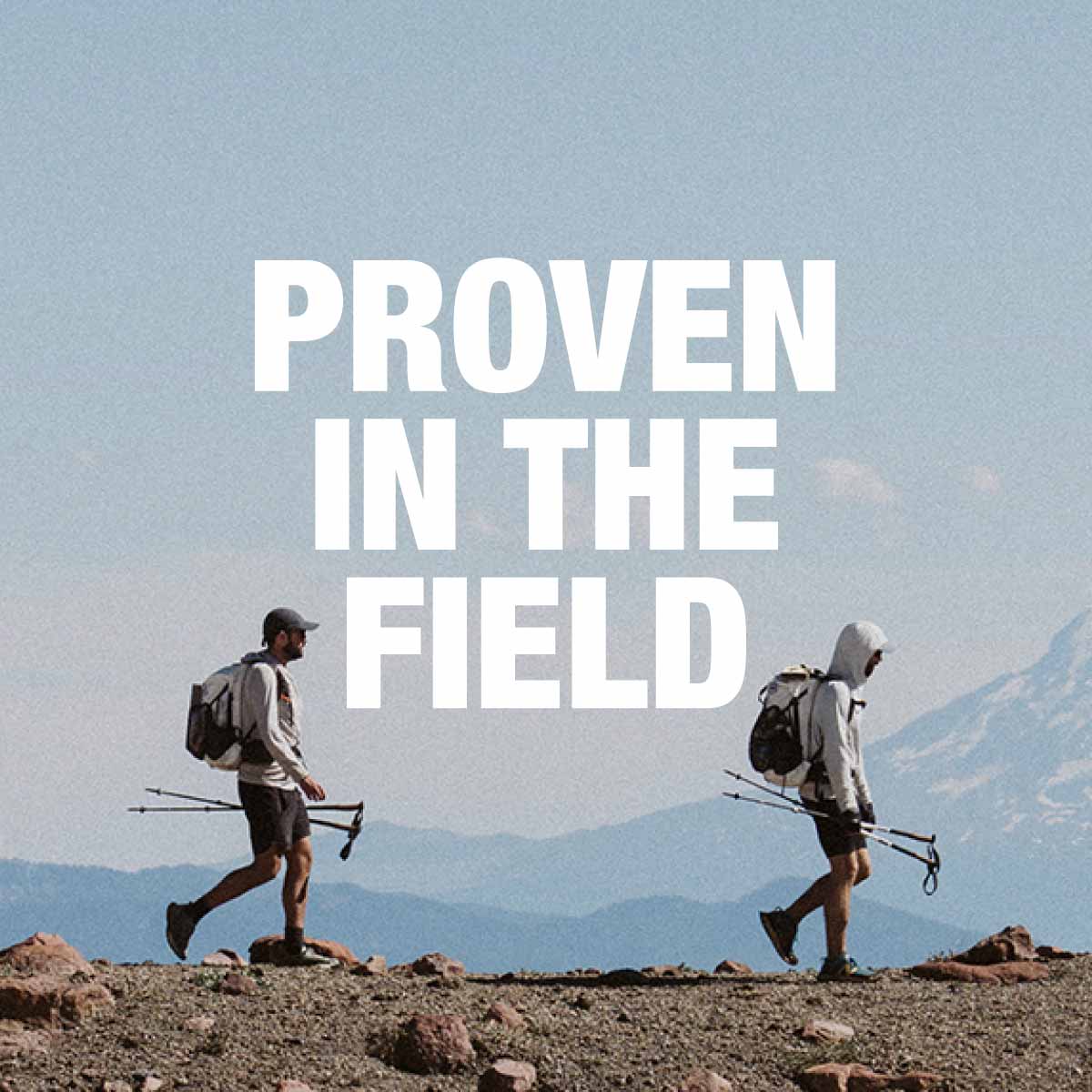 Two people hiking with backpacks and poles on a mountainous landscape with 'Proven in the Field' text.