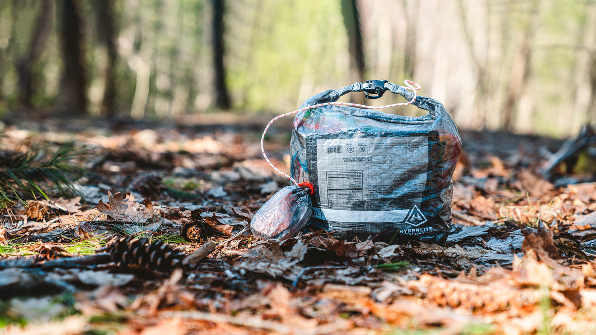 10L Roll-Top Food Bag Kit by Hyperlite Mountain Gear sitting on the forest floor