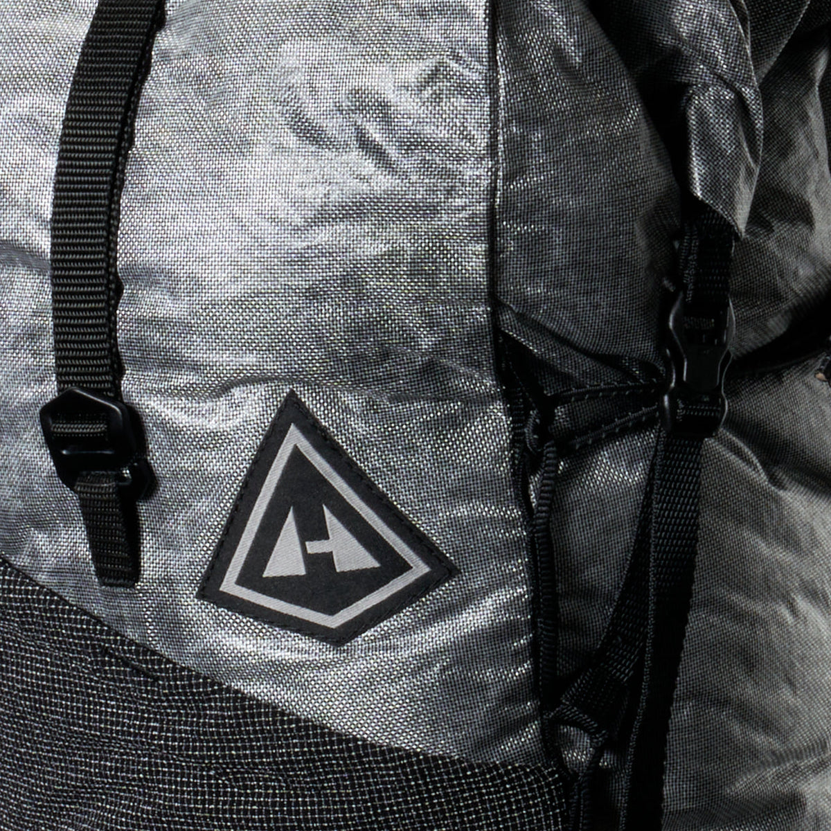 Close-up of a Pemi 15 pack with a logo on the back and ALUULA fabric