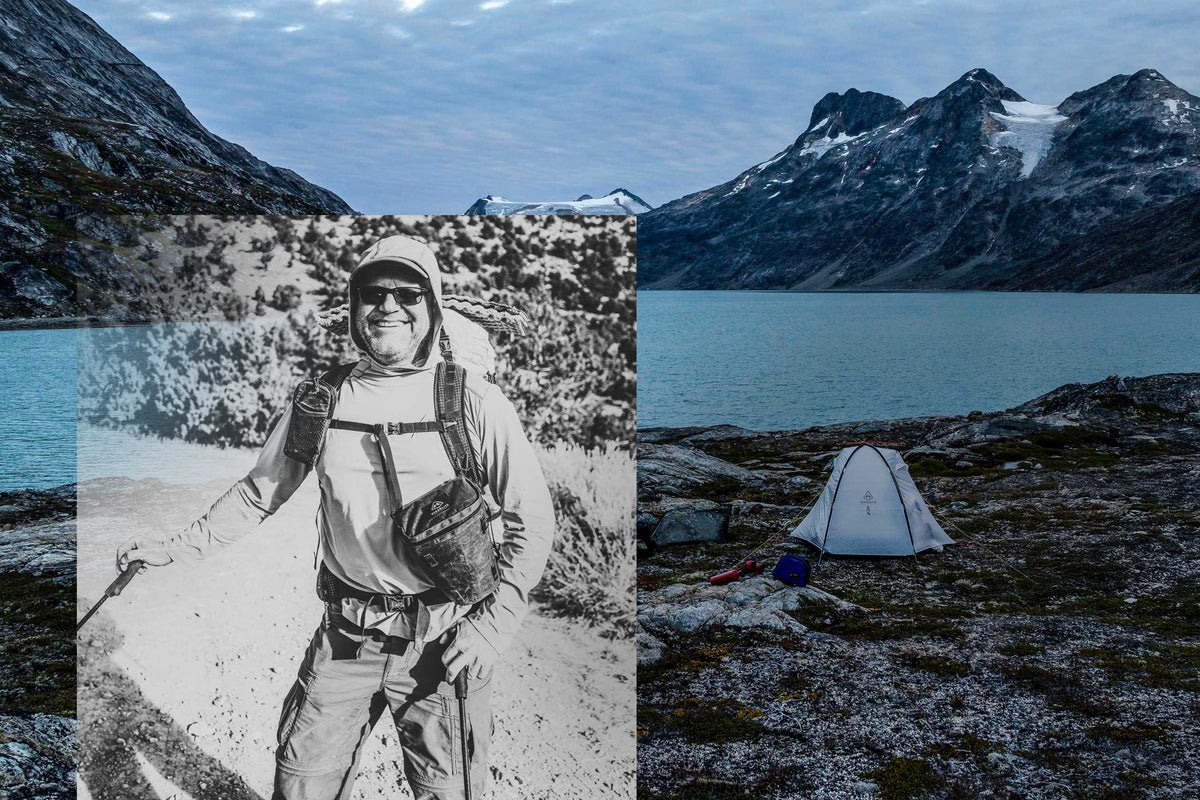 Camping scene with a tent by a lake and mountains, with a black and white photo of a person in outdoor gear.